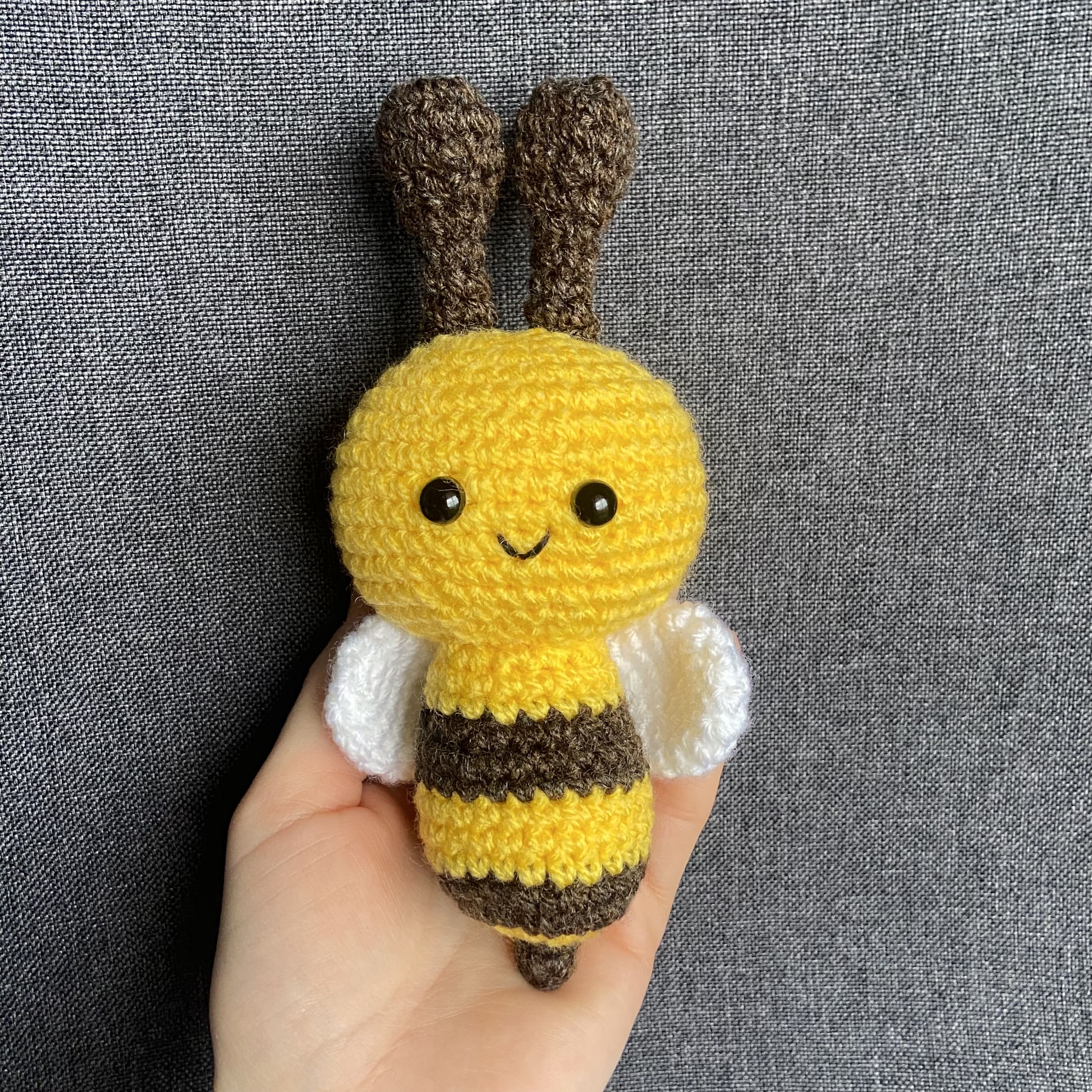 Peluche abeille amigurumi mâle au crochet tenue en main